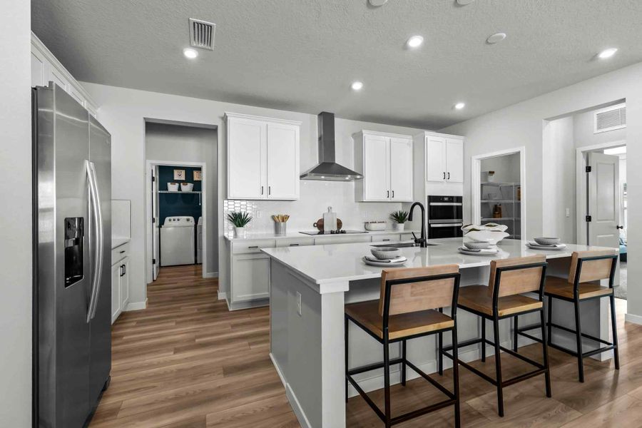 A kitchen with white cabinets.