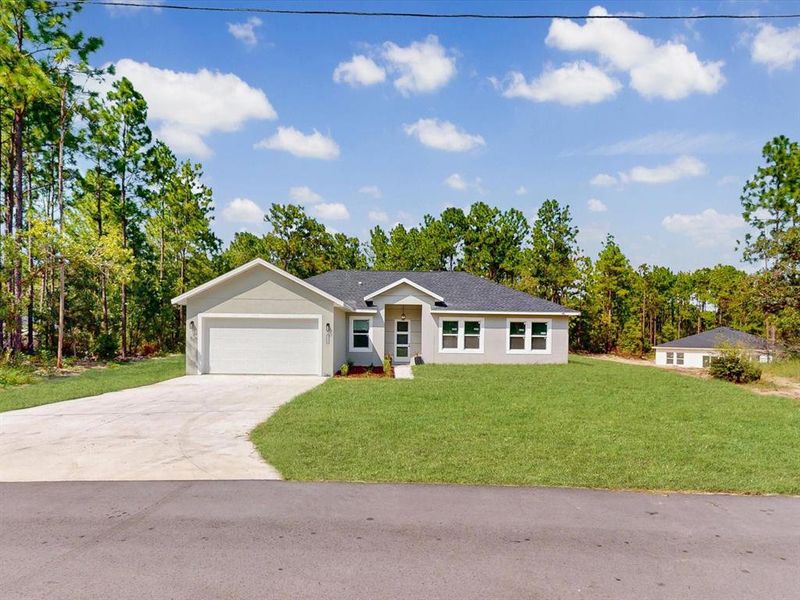 Front exterior of a new home in , Ocala, FL, highlighting curb appeal (Image 1). Front exterior of a new home in , Ocala, FL, highlighting curb appeal (Image 1).