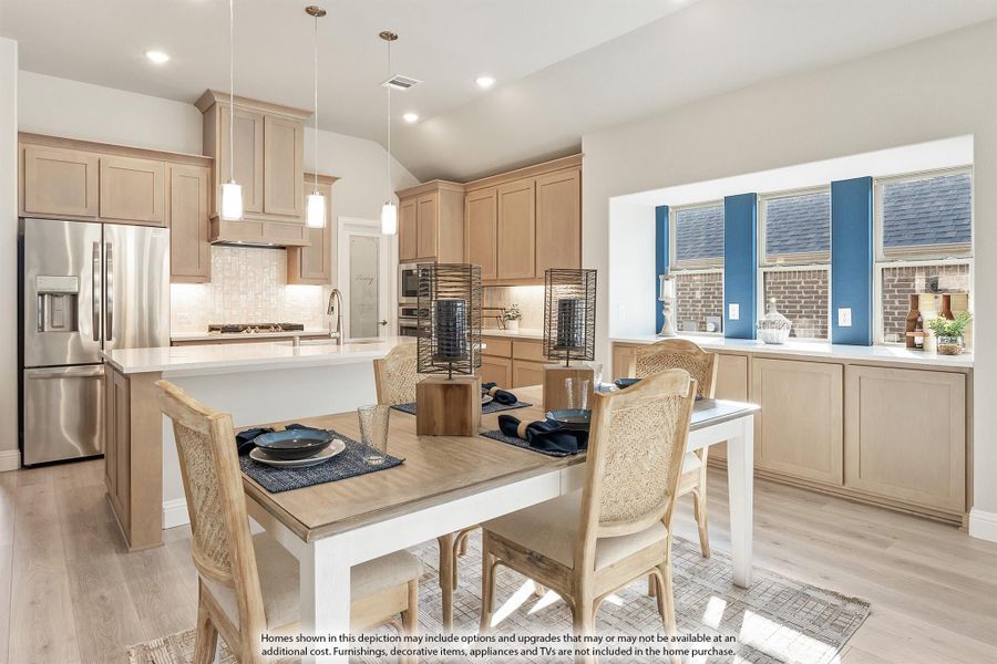 Open kitchen and dining area with light wood cabinets, kitchen island, stainless steel fridge, and dining table for four. Open kitchen and dining area with light wood cabinets, kitchen island, stainless steel fridge, and dining table for four.