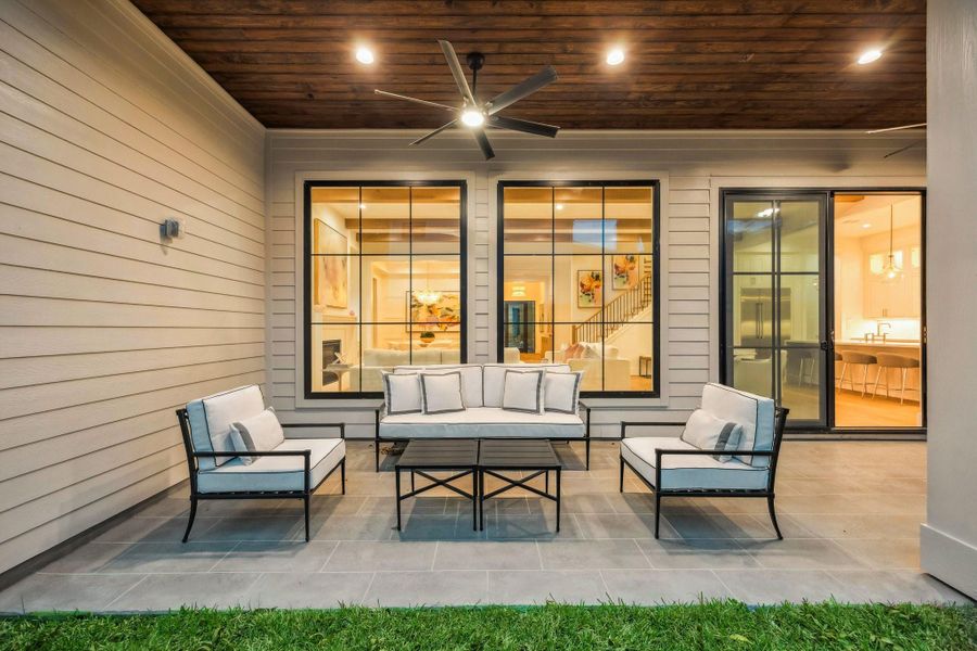 Covered Patio with Tile, Stained Wood Ceiling, Two Ceiling Fans and a Grill and Bar Area.