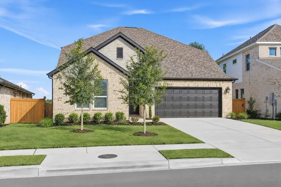 Front exterior of a new home in Parkside on the River, Georgetown, TX, highlighting curb appeal (Image 2). Front exterior of a new home in Parkside on the River, Georgetown, TX, highlighting curb appeal (Image 2).