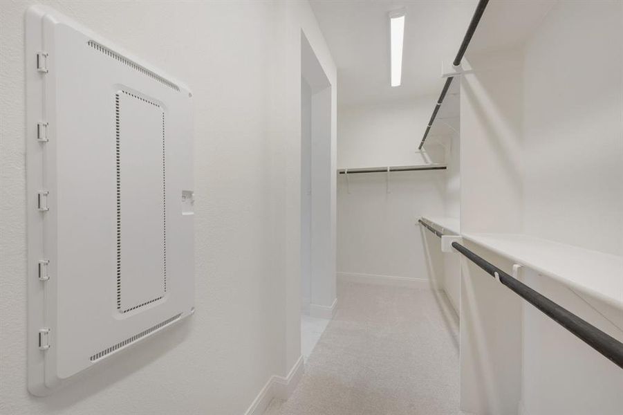 Walk-in closet featuring white shelving and dark-finish hanging rods