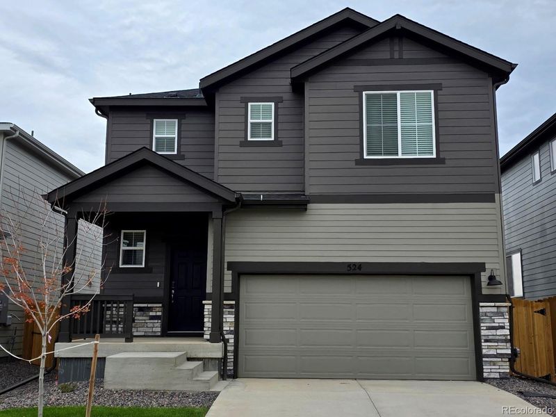 Front exterior of a new home in Lake Bluff, Greeley, CO, highlighting curb appeal (Image 1). Front exterior of a new home in Lake Bluff, Greeley, CO, highlighting curb appeal (Image 1).