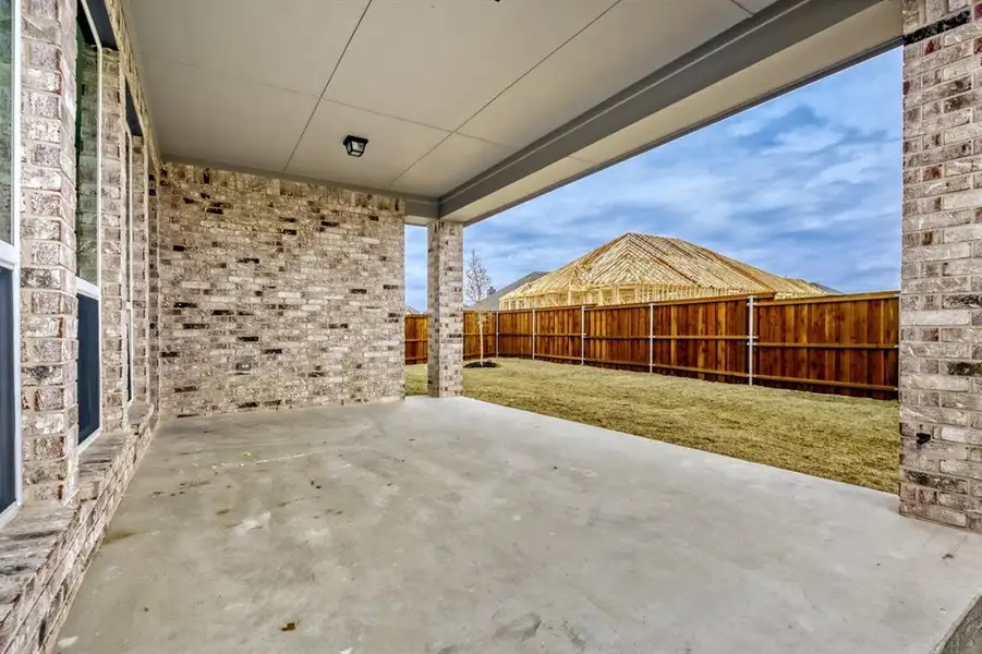 Fenced backyard featuring a patio