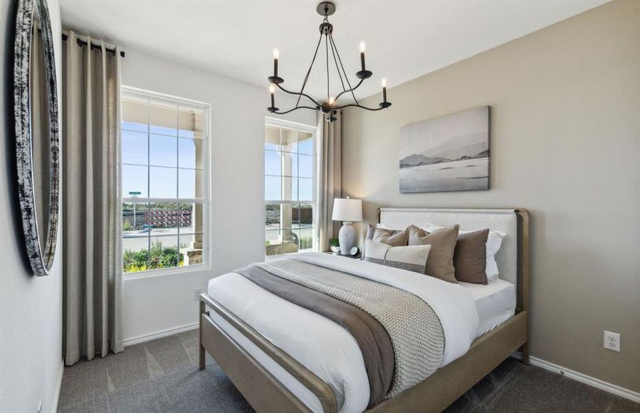 Spacious secondary bedroom with large windows *Model Representation*