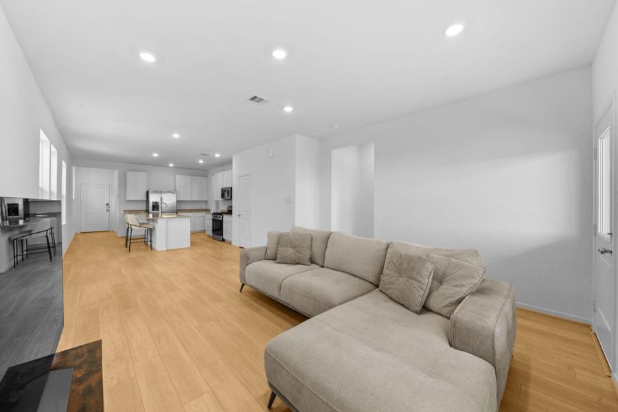 The living room is conveniently located near the kitchen and backyard.