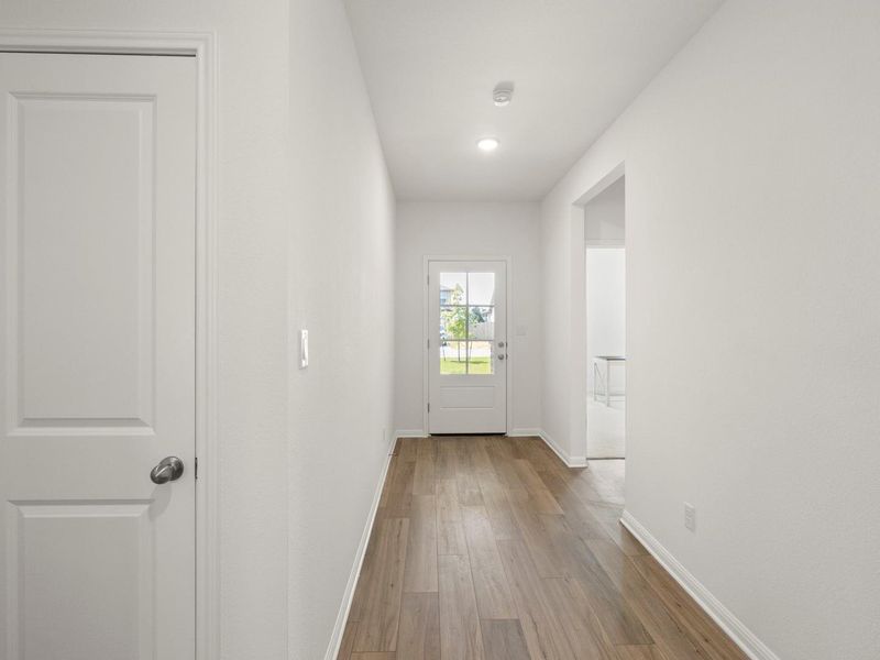 A welcoming entry hall with durable flooring guides you into the residence.