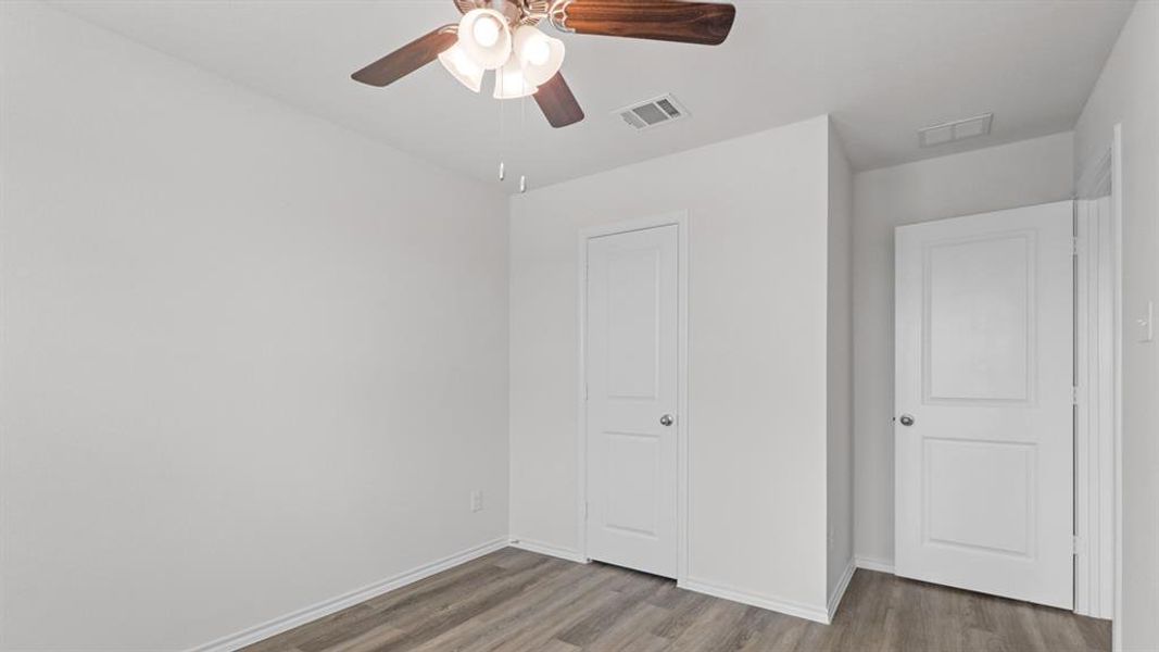 Light gray wood-finish flooring complements the crisp white walls and doors Light gray wood-finish flooring complements the crisp white walls and doors
