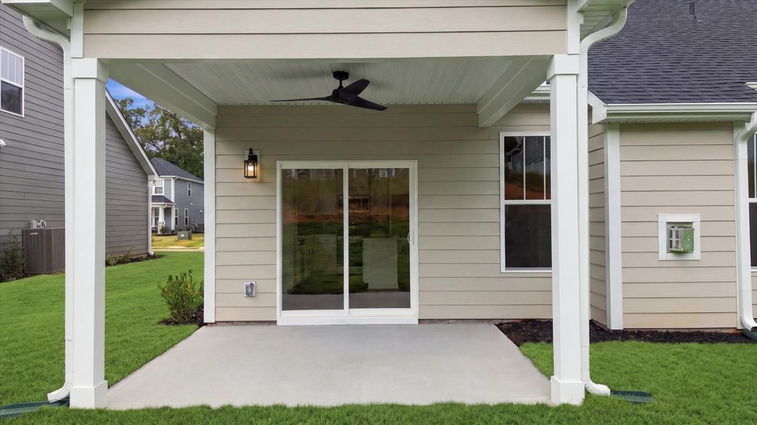 Superior curb appeal continues to the back with a refined, covered outdoor living space in Anderson, SC