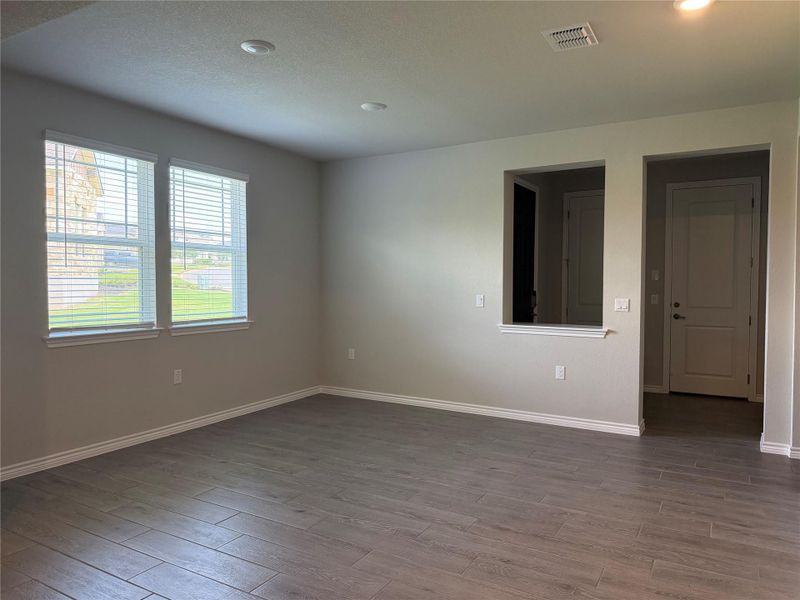 Ample natural light illuminates this open living space, featuring durable tile flooring and recessed lighting.