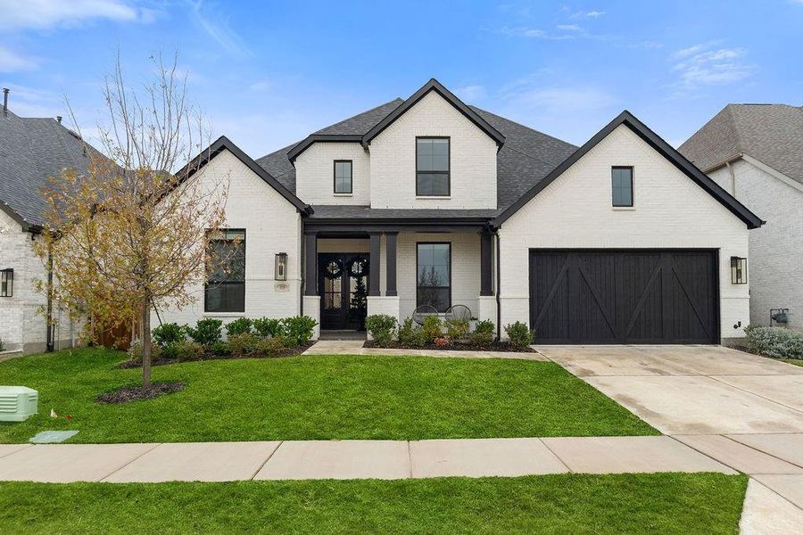 Front exterior of a new home in Mustang Lakes: 86ft. lots, Celina, TX, highlighting curb appeal (Image 1). Front exterior of a new home in Mustang Lakes: 86ft. lots, Celina, TX, highlighting curb appeal (Image 1).