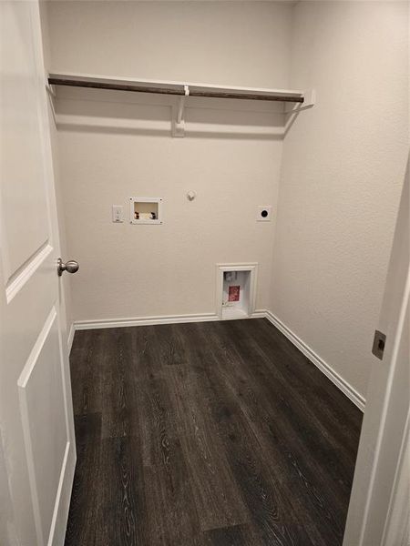 Washroom featuring hookup for a gas dryer, hookup for a washing machine, wood-type flooring, and hookup for an electric dryer