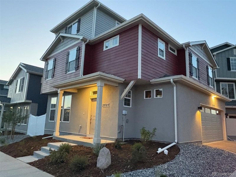 Front exterior of a new home in Green Valley Ranch, Aurora, CO, highlighting curb appeal (Image 26).
