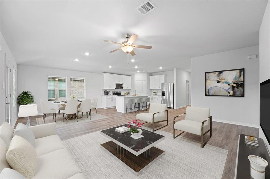 Living area with a ceiling fan, light wood-style Virtually staged. Living area with a ceiling fan, light wood-style Virtually staged.