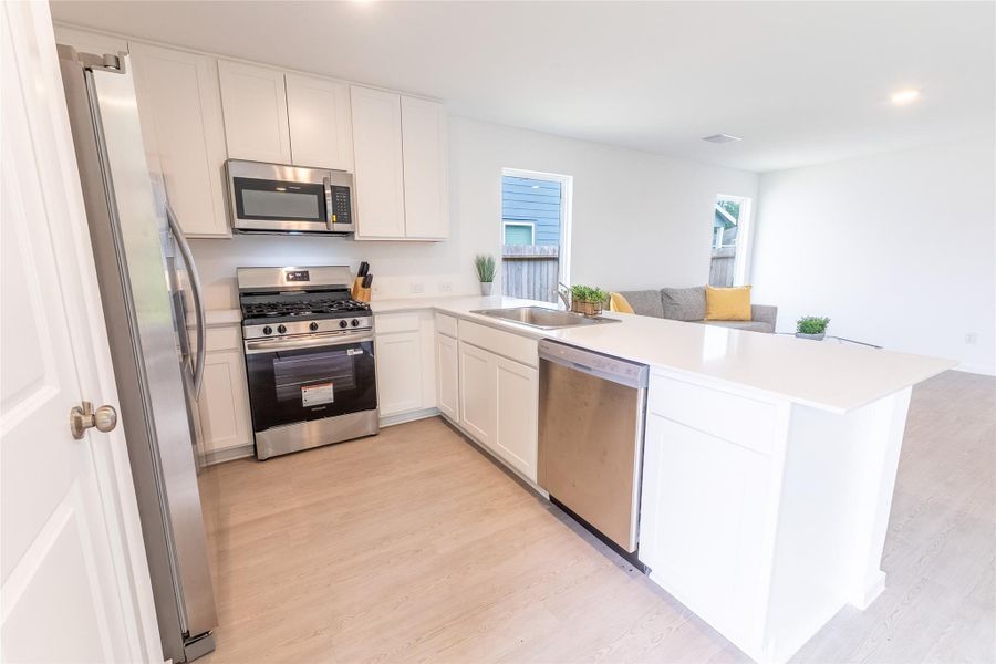 The spacious kitchen offers stainless steel appliances, bright white cabinets and counters, lots of cabinet space, and a breakfast bar perfect for casual dining and entertaining. The spacious kitchen offers stainless steel appliances, bright white cabinets and counters, lots of cabinet space, and a breakfast bar perfect for casual dining and entertaining.
