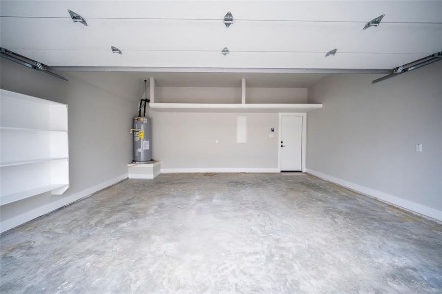 Garage with water heater and baseboards