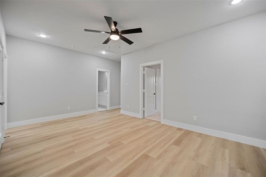 Unfurnished bedroom with recessed lighting, baseboards, attic access, and light wood-style flooring