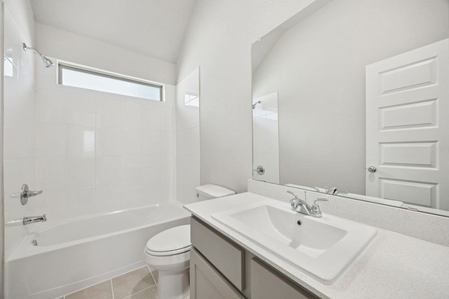 Full bathroom featuring vanity, washtub / shower combination, and tile patterned floors