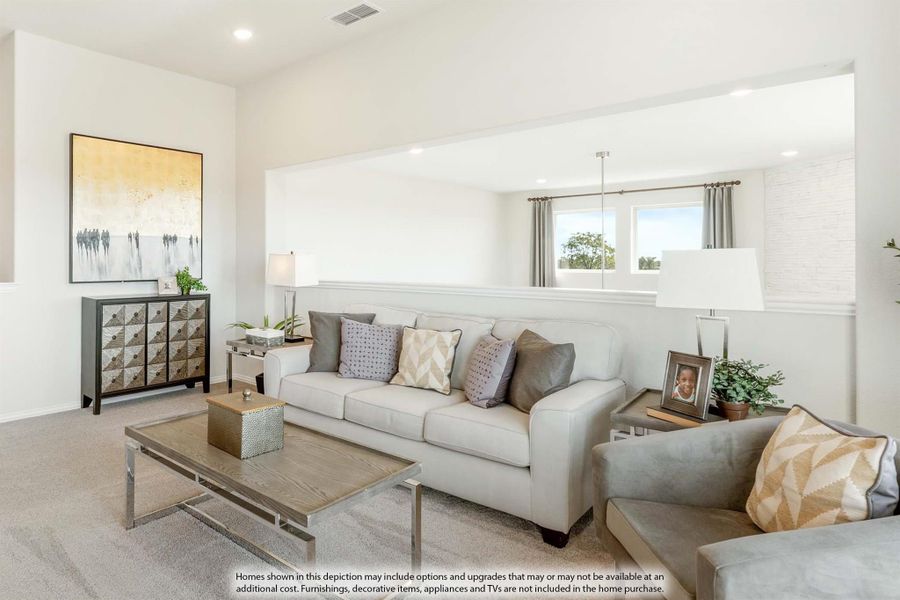 Living room with light gray sofa, coffee table, and neutral carpet in an open layout with high ceilings
