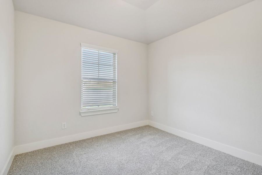 Guest bedroom in the Hughes floorplan at a Meritage Homes community.