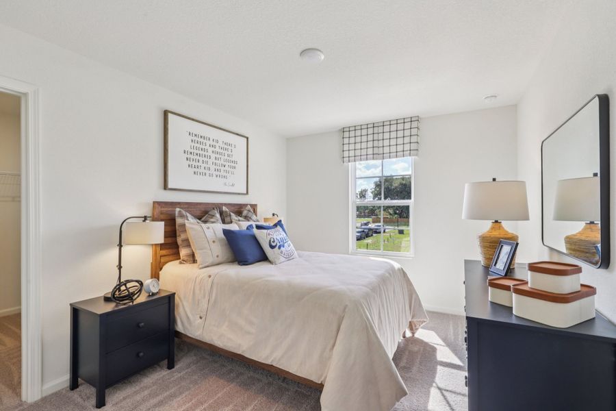 A bedroom with a bed and a mirror. A bedroom with a bed and a mirror.