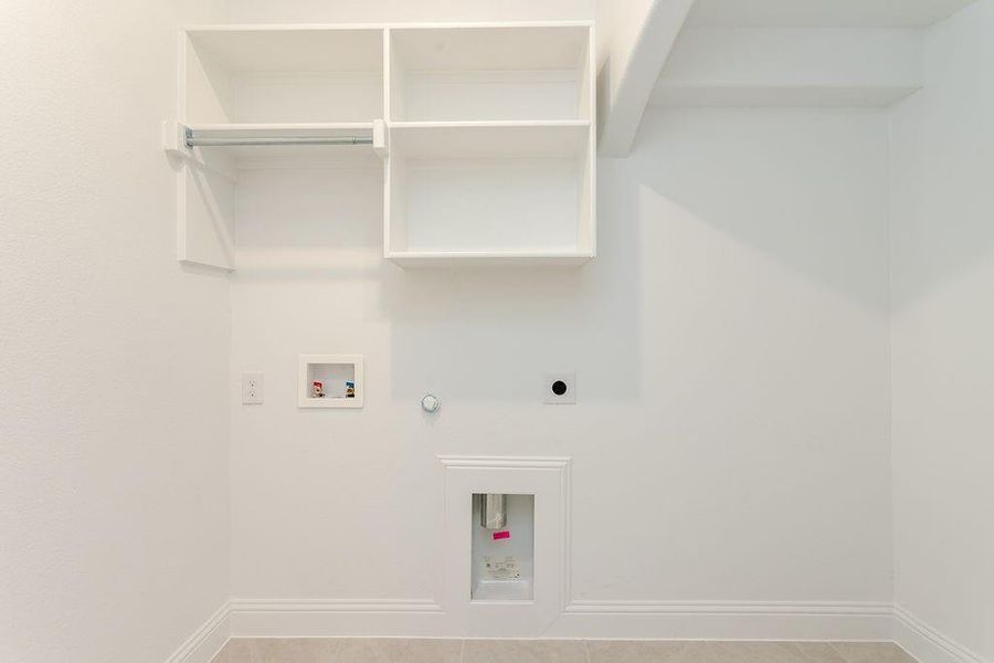 Laundry area featuring gas dryer hookup, light tile patterned floors, hookup for an electric dryer, and washer hookup