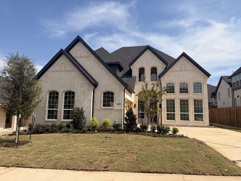 Front exterior of a new home in Estates at Rockhill, Frisco, TX, highlighting curb appeal (Image 2). Front exterior of a new home in Estates at Rockhill, Frisco, TX, highlighting curb appeal (Image 2).