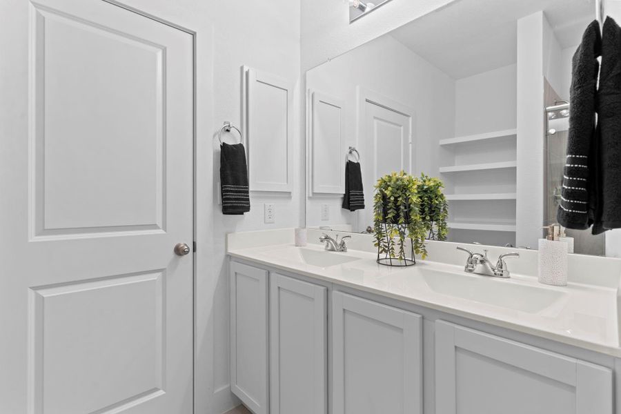 A second angle of the primary bath highlights the cultured marble double-sink vanity and modern finishes, with a direct connection to the primary bedroom through a convenient interior door—perfectly blending comfort and flow. **Image Representative of Plan Only and May Vary as Built**. A second angle of the primary bath highlights the cultured marble double-sink vanity and modern finishes, with a direct connection to the primary bedroom through a convenient interior door—perfectly blending comfort and flow. **Image Representative of Plan Only and May Vary as Built**.