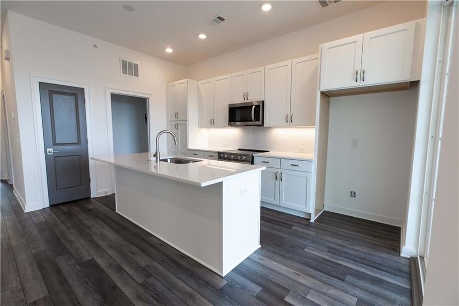 Kitchen features pantry plus powder room on main level *Home is Under Construction. Photos shown are from other TPG Communities to display how the home will live*