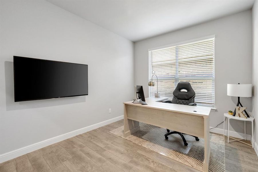 Office space featuring wood finished floors and baseboards