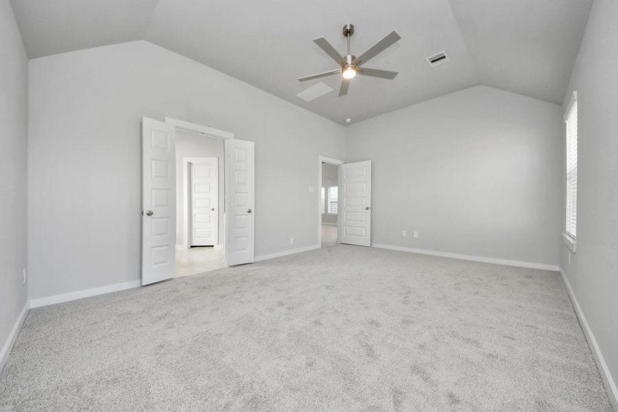 Come and unwind after a long day in this magnificent primary suite! This spacious room features plush carpet, warm paint, high ceilings and large windows with privacy blinds. Sample photo of completed home with similar floor plan. Actual colors and selections may vary.