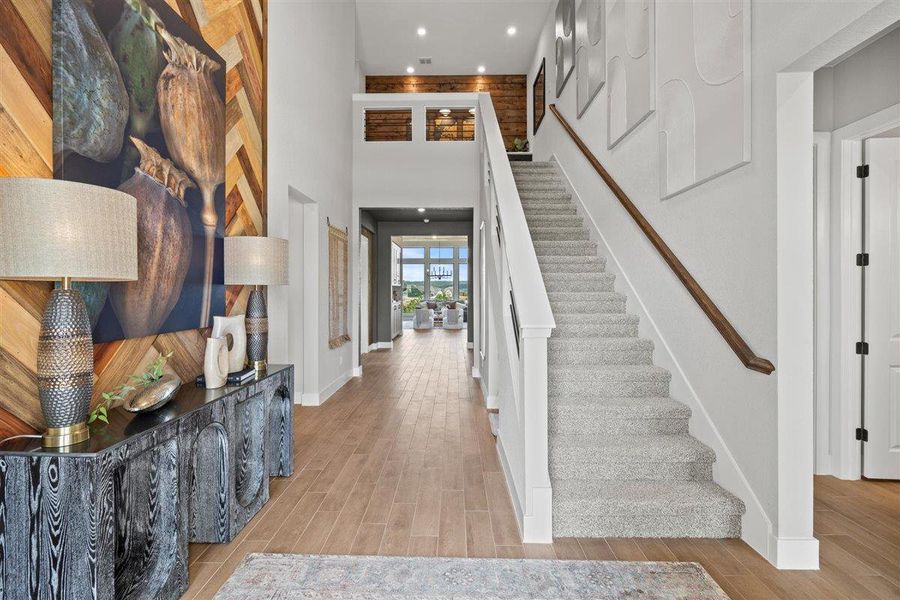 Foyer featuring wood tiled floors, a high ceiling, and recessed lighting