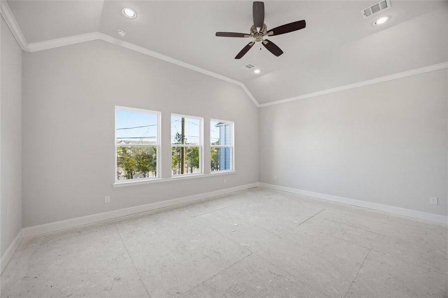 Primary Bedroom Retreat – Vaulted ceilings, plush carpeting, and natural light combine to create a peaceful and spacious haven.