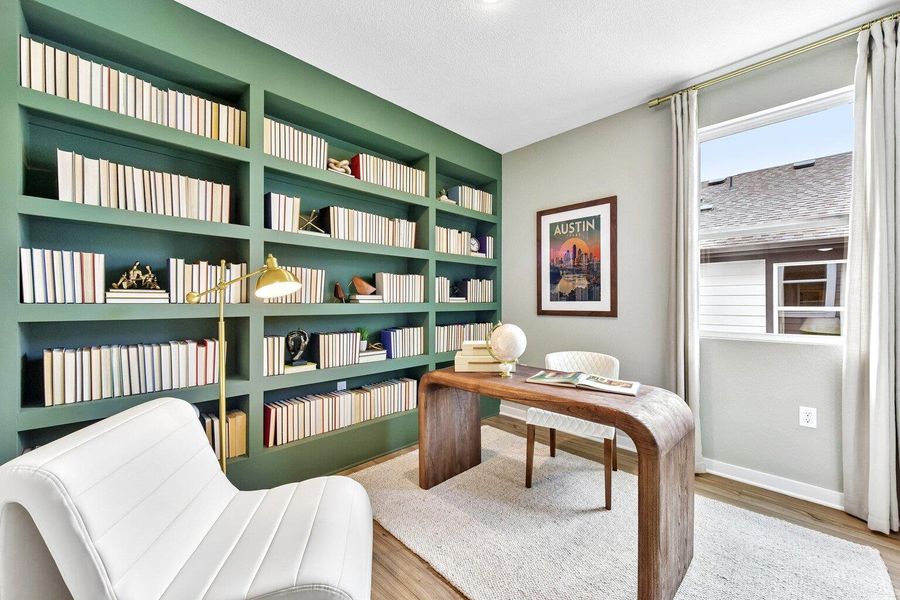 Custom built-in shelving and warm wood floors define this functional study space. Custom built-in shelving and warm wood floors define this functional study space.
