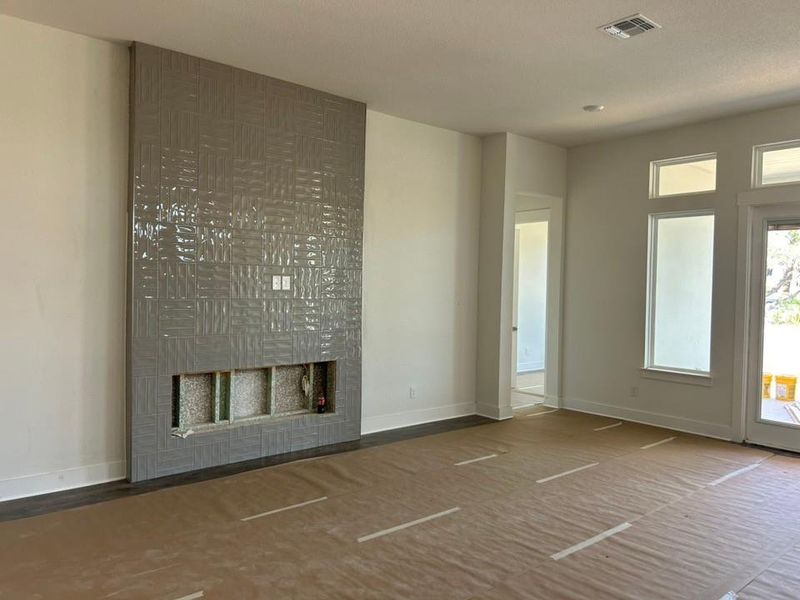 Unfurnished living room with a fireplace and baseboards Unfurnished living room with a fireplace and baseboards