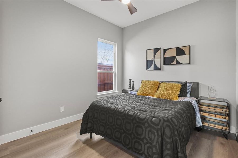 Bedroom featuring hardwood / wood-style floors and ceiling fan