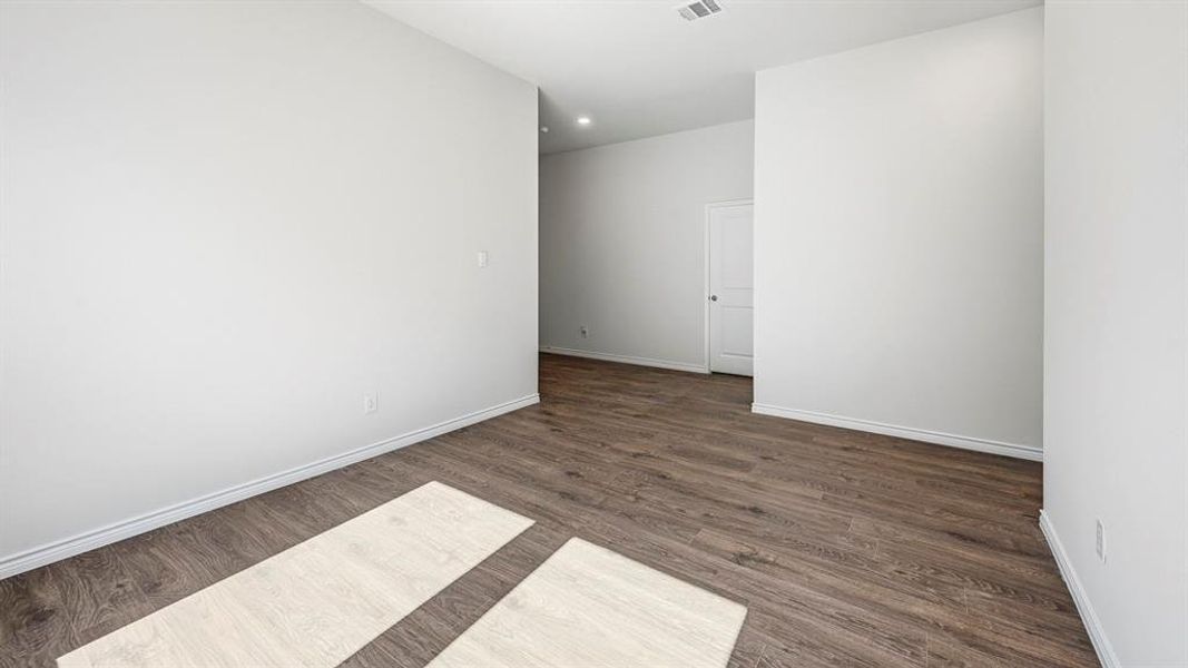 Spare room with dark wood finished floors and recessed lighting