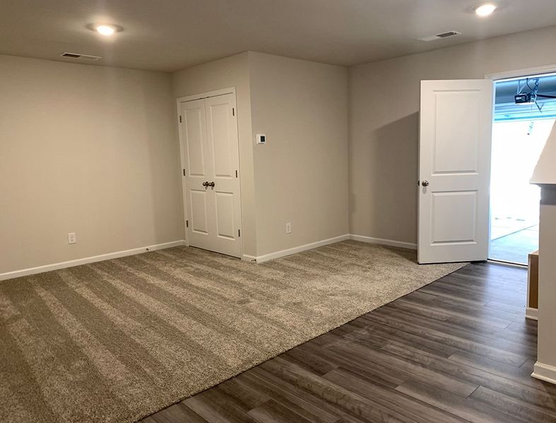 Fully finished basement with entrance into garage.