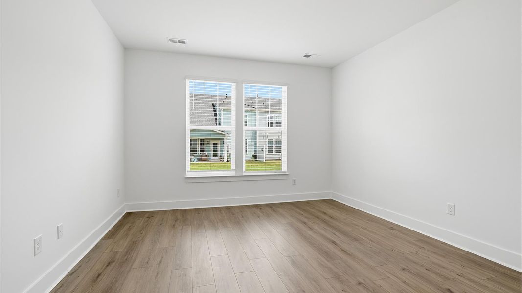 First-class hardwood floors and tasteful finishes elevate the private retreat of this exceptional primary suite First-class hardwood floors and tasteful finishes elevate the private retreat of this exceptional primary suite