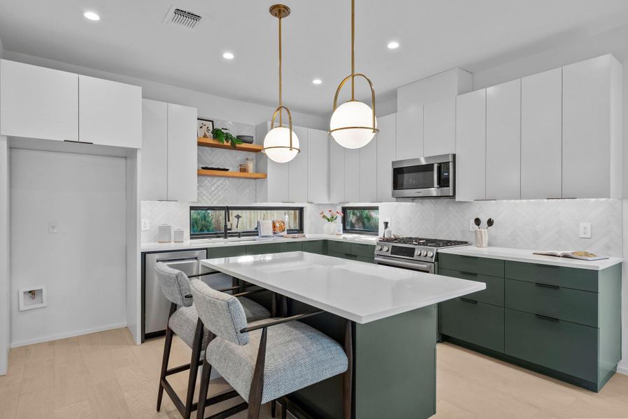 Kitchen with modern cabinets, backsplash, a kitchen bar, designer pendant lights Kitchen with modern cabinets, backsplash, a kitchen bar, designer pendant lights