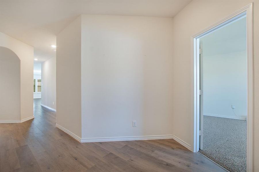 Empty room with light hardwood / wood-style floors