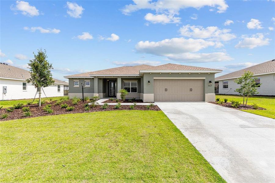 Front exterior of a new home in , Ocala, FL, highlighting curb appeal (Image 2). Front exterior of a new home in , Ocala, FL, highlighting curb appeal (Image 2).
