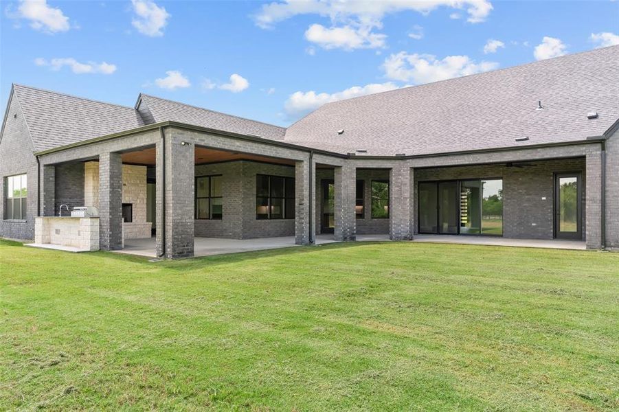 Oversized covered back patio with many areas for entertaining.