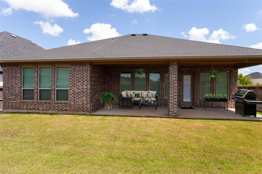 Great backyard with an extended covered patio, offering a perfect space for outdoor relaxation and entertainment. The lawn is well-maintained, adding to the property's appeal.