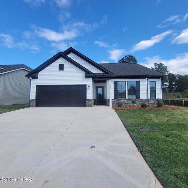 Front exterior of a new home in Langston Place, Perry, GA, highlighting curb appeal (Image 1). Front exterior of a new home in Langston Place, Perry, GA, highlighting curb appeal (Image 1).
