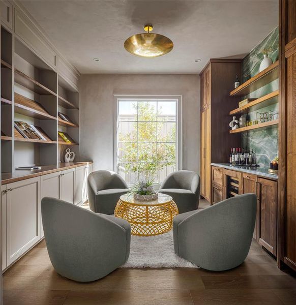 Living area featuring bar with sink and dark wood-type flooring Living area featuring bar with sink and dark wood-type flooring