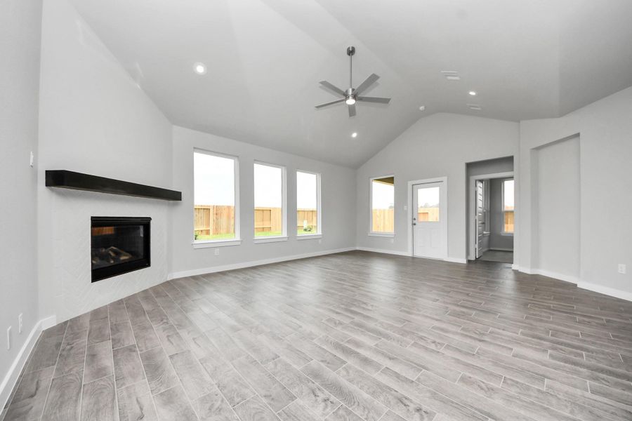 Take another glimpse into the heart of the home with this additional view of the family room—a sprawling space ready to accommodate all your gatherings. Sample photo of completed home with similar floor plan. Actual colors and selections may vary.