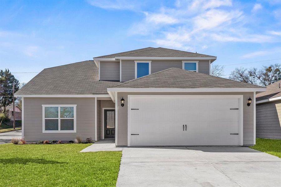 Front facade featuring a front lawn and a garage