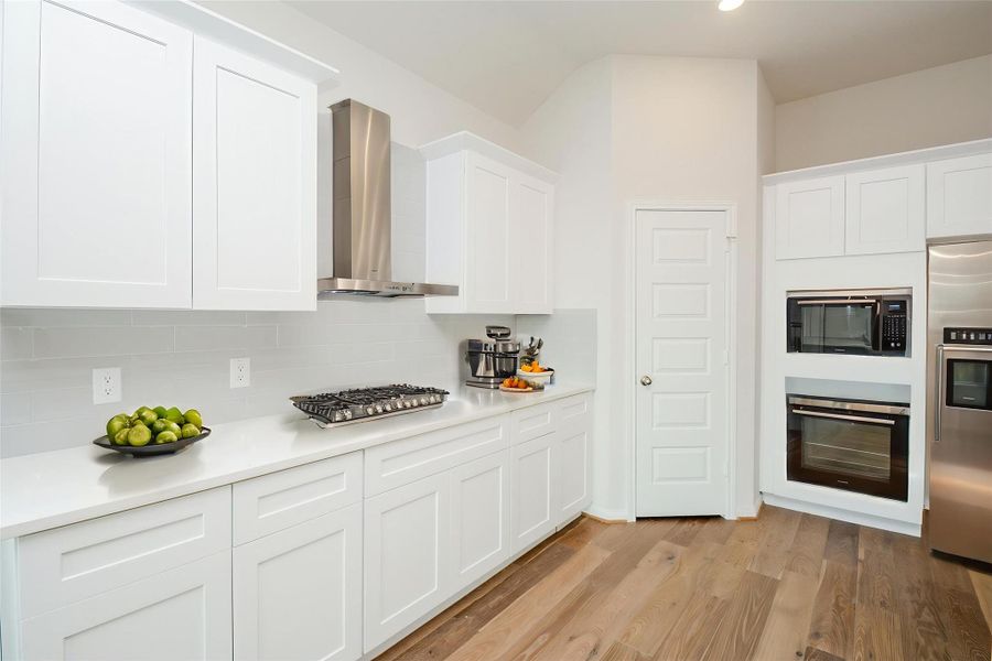 Notice the crisp, white cabinetry that offers plenty of storage to hold all of your culinary necessities.