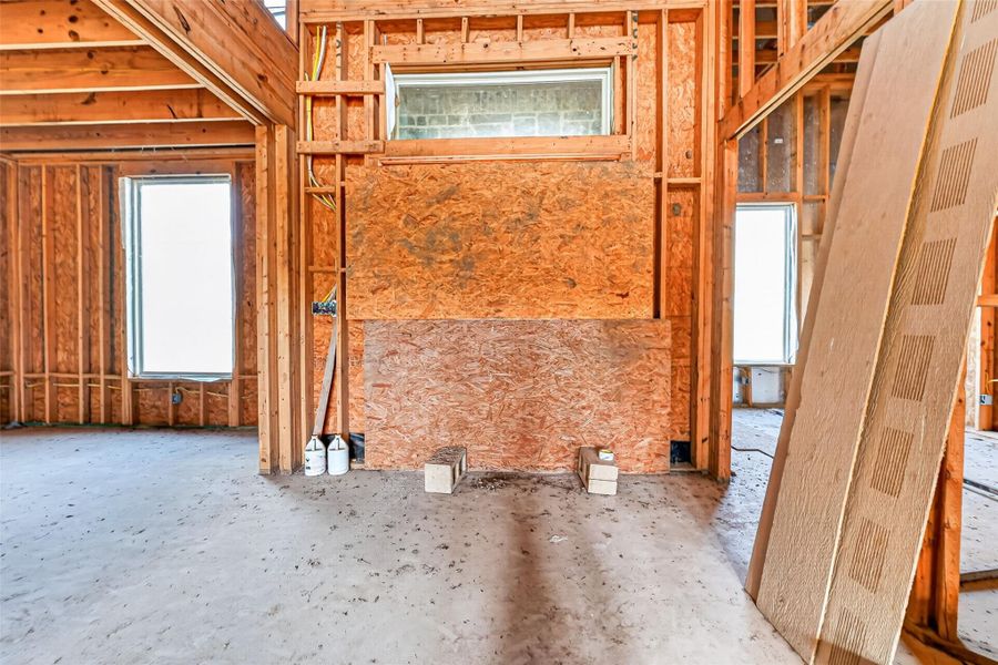 Open unfinished space showcasing framing and build progress.